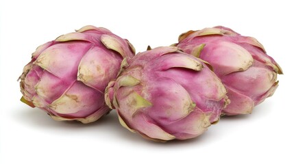 Fototapeta premium Fresh dragon fruit pitaya trio arranged on a white background showcasing vibrant pink skin and unique texture for healthy eating concept.