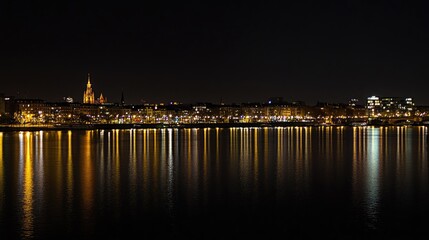 Frankfurt city skyline illuminated at night reflecting on the Main River with vibrant lights and historic architecture