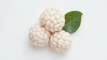 Custard apple fruit with green leaf isolated on a white background showcasing its unique texture and natural appeal