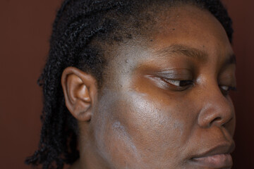 Sunscreen applied on brown skin, sunscreen leaving a white cast on dark brown skin, sun protection product on brown skin