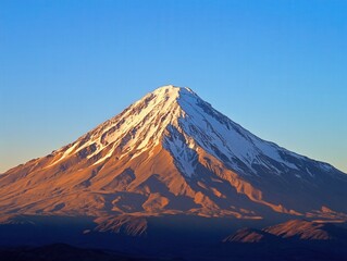 Fototapeta premium majestic snow-capped mountain under clear blue sky
