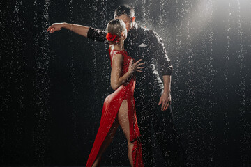 A couple of dancers on a black background in a studio in the aqua zone