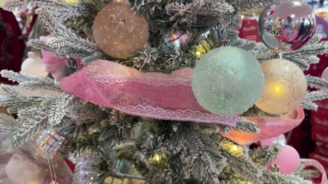 4k footage close up of lighted Christmas tree ornaments and decorations. Mistletoe, baubles, and bell with Interactive sparkling christmas twinkle lights or icicle lights.