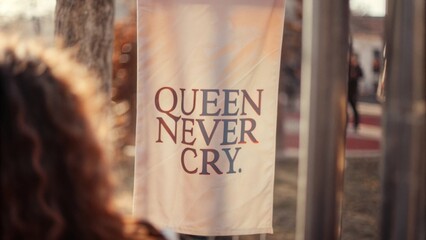 Empowering message inspiring strength 'queen never cry banner in elegant event setting emotional overtones unique perspective