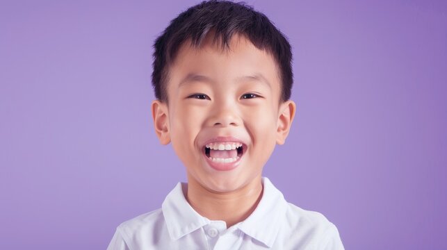 A young boy with a missing front tooth smiling and showing his teeth set against a purple background. - Powered by Adobe