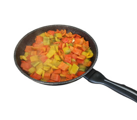 Sizzling diced bell peppers cooking in frying pan with transparent background