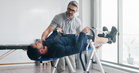 Physiotherapy, consulting and inversion table with man in clinic for back pain, spine decompression...