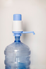 Manual water pump dispenser isolated against white background vertical