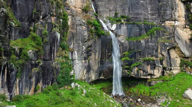 Aerial view of jogini waterfall surrounded by cedar forest in the himalayas in manali, himachal pradesh, India