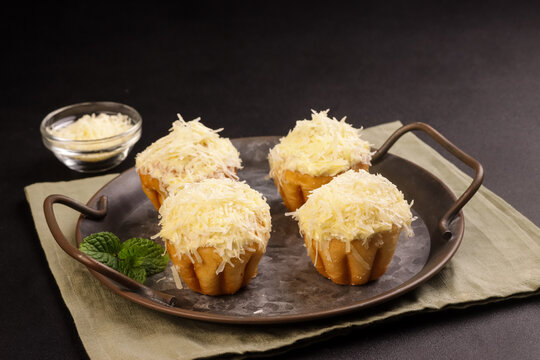 Ensaymada is Filipino Soft Bread, Covered with Butter and Sugar then Topped with Greated Cheese. 