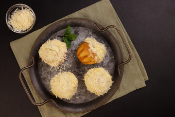 Ensaymada is Filipino Soft Bread, Covered with Butter and Sugar then Topped with Greated Cheese. 