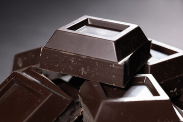 Pieces of chocolate on dark background