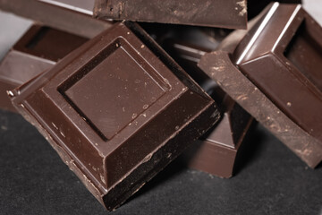 Pieces of chocolate on dark background