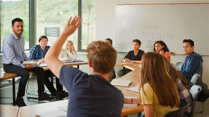 Male Student Asking Tutor Question Tutor In High School College Or University Students Maths Class