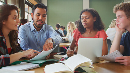 Male And Female Teachers With Students In High School College Or University Classroom Lesson
