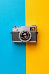 Fototapeta premium Blue and yellow background with a retro camera on it, simple and minimalistic style, 