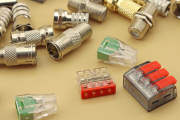 Metal F-connectors for connecting coaxial cable. Close-up. Soft focus.