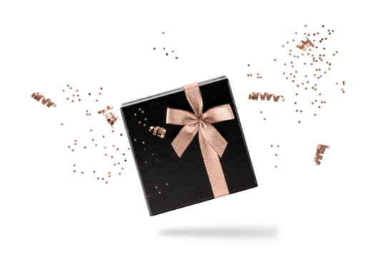 Black gift box with copper golden ribbon and confetti flying isolated on white background. Black friday or celebration concept. Ribbon and confetti in trendy color  Mocha Mousse.