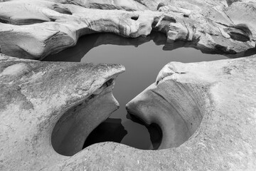 Pothole landforms on the Yangtze River. Located in Qilin Square, Luzhou City, Sichuan Province. Black and white photo.