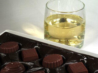 Glass of white wine and candies