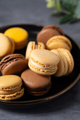 Macarons cookies, stack of french macarons in a plate. Sweet dessert, sugar