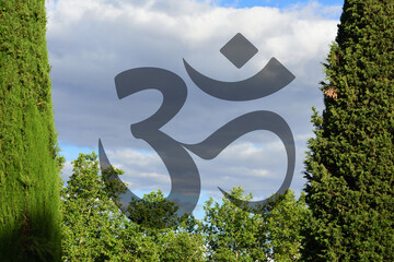 Om symbol transparent on trees and sky background. Symbol of Buddhism and Hinduism religions.