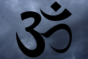 Om symbol on sky background. Symbol of Buddhism and Hinduism religions.