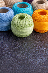 Multicolor yarn for knitting, knitting needles and scissors. Home storage concept and hobby.Raffia is an organic, ecological, wood fiber that is easy to crochet.