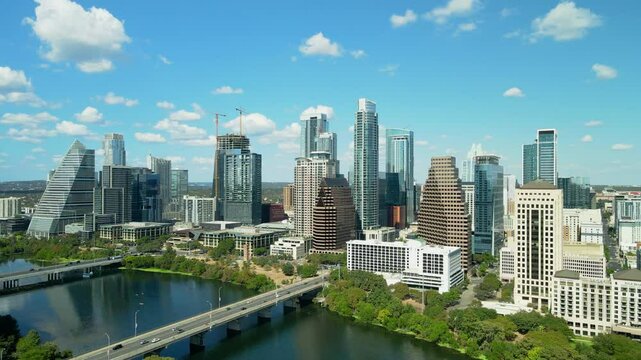 Parallax drone aerial shot downtown Austin on a sunny day with Colorado River. Establishing view of the c