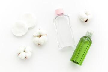 Bottles of facial toner and cleanser, top view. Cosmetic products for skin care