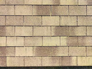 Close-up look at the worn texture and colors of roofing tiles, highlighting wear from exposure to the elements