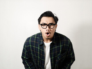 Adult Asian man looking to camera with angry expression isolated on white background