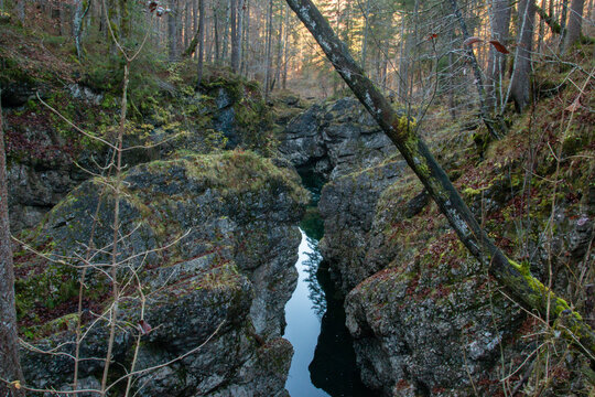 A stream and waterfall in the Walchenklamm gorge in the Bavarian Forest in late autumn. Rocks covered in moss and trees without leaves.
mysterious and enigmatic.
