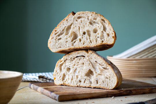 Sourdough home made round bread loaf, sliced in half. 