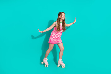 Naklejka premium Full size photo of pretty teen girl ride roller cheerful have fun wear trendy plaid pink outfit isolated on cyan color background