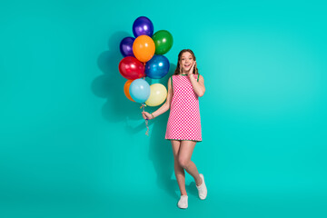 Full length photo of lovely teen lady hold air balloons amazed dressed stylish pink plaid garment isolated on cyan color background