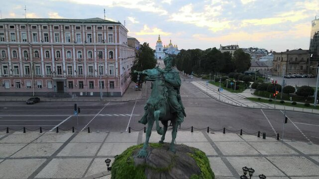 Pull-back drone footage of the Bohdan Khmelnytsky Monument at sunset in Sophia Square, Kyiv, Ukraine