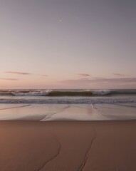 Sunset on the beach with waves crashing in