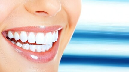 Fototapeta premium Close-up of a smiling woman with bright white teeth against a soft blue background.