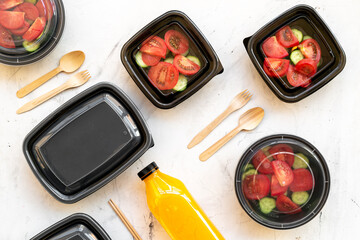 Tomatoes salad in plastic delivery tray, top view. Catering concept