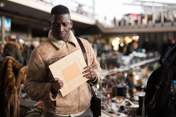 Man chooses antiques at a flea market