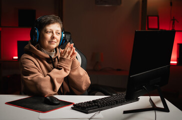 A gamer wearing headphones is plotting something and watching with a conspiratorial expression on...