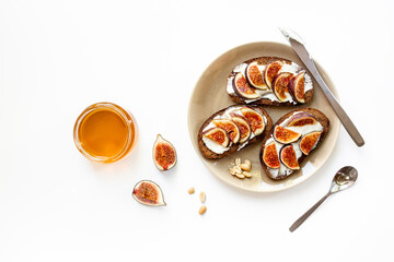 Top view of breakfast table with fig, cheese and honey sandwiches