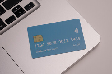 Close up of debit and credit cards placed in front of laptop. online shopping payment and retail...