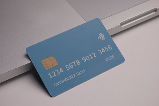 Close up of debit and credit cards placed in front of laptop. online shopping payment and retail concept. mockups and fake credit cards. Color credit card.