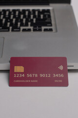 Close up of debit and credit cards placed in front of laptop. online shopping payment and retail...