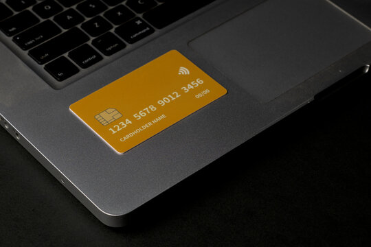 Close up of debit and credit cards placed in front of laptop. online shopping payment and retail concept. mockups and fake credit cards. Color credit card.