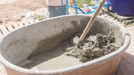 Fototapeta premium Cement mixed with sand in a cement container with shovel tool for work