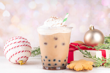 Christmas cafes menu background, iced festive Gingerbread boba tea bubble balls Oat Milk Chai tea or Latte with non-dairy whipped creamer, Gingerbread syrup, tapioca balls, cookies crumbs, spices