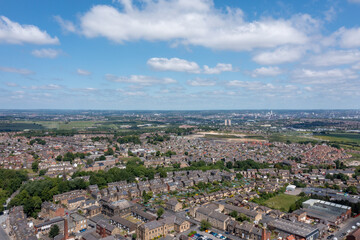 Aerial photo of the village of Morley in Leeds, West Yorkshire in the UK, showing a birds eye drone view of the street and housing estates on a sunny day in the summer time